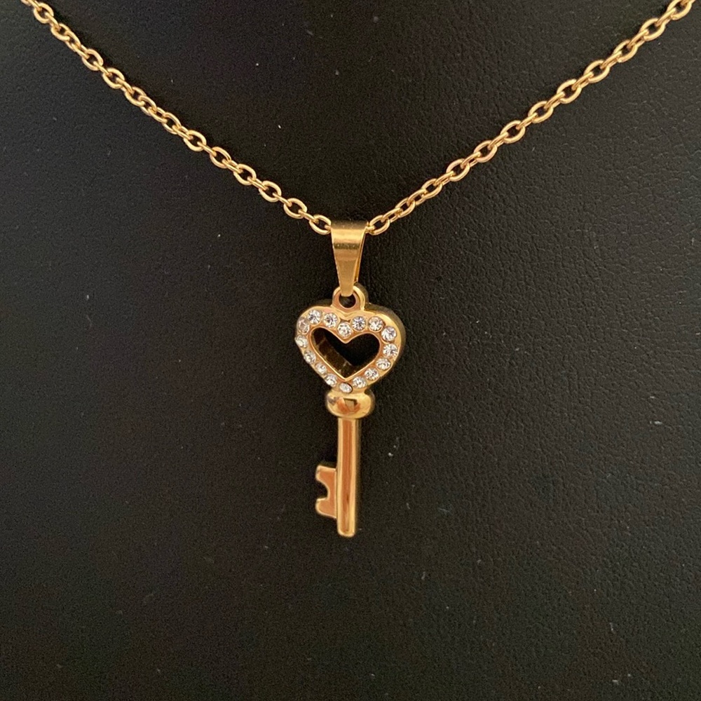 Stainless steel heart key pendant on chain.